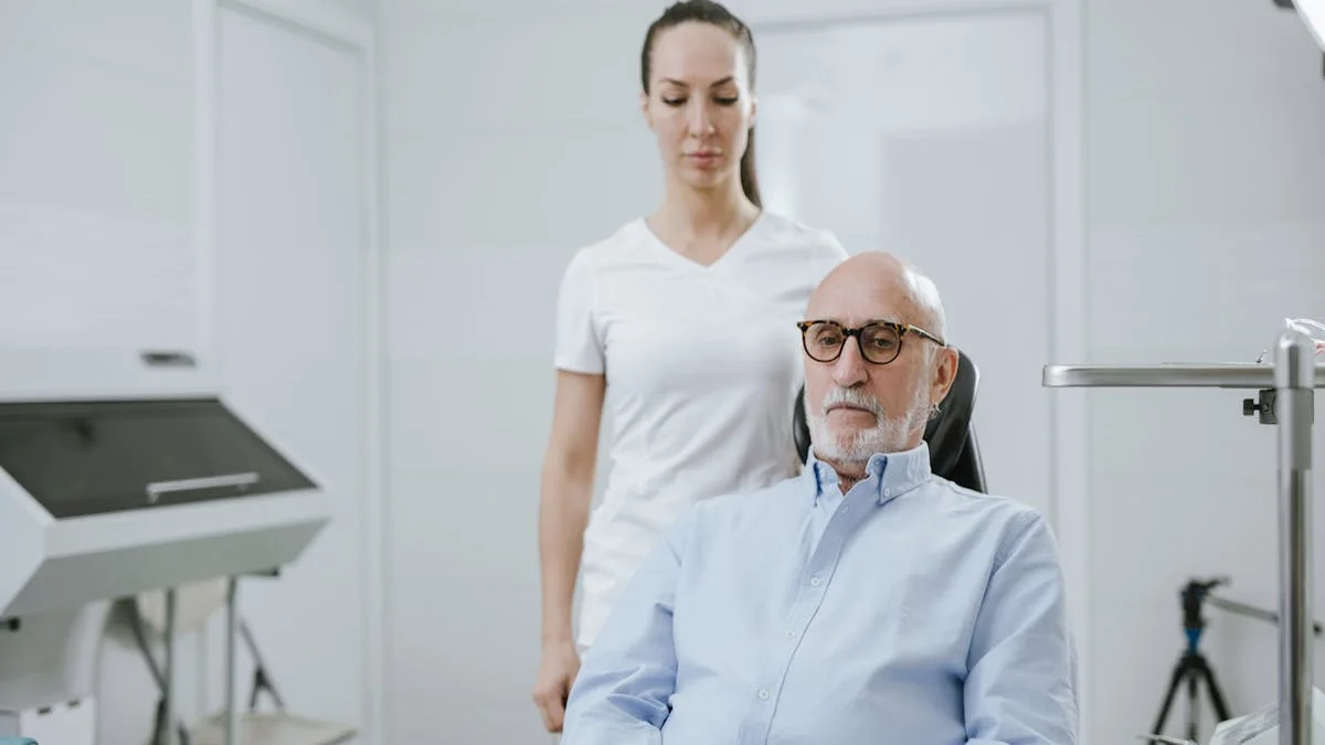 A senior shows a printed medication list to a doctor in an exam room