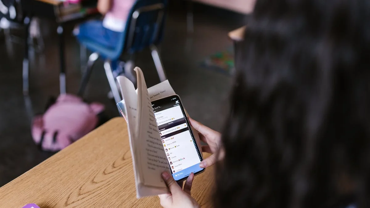 A teen studying in a distraction-free zone with their phone locked down by a focus app