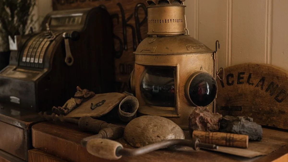 A grandmother's china cabinet filled with objects, each item glowing faintly as if holding a hidden story